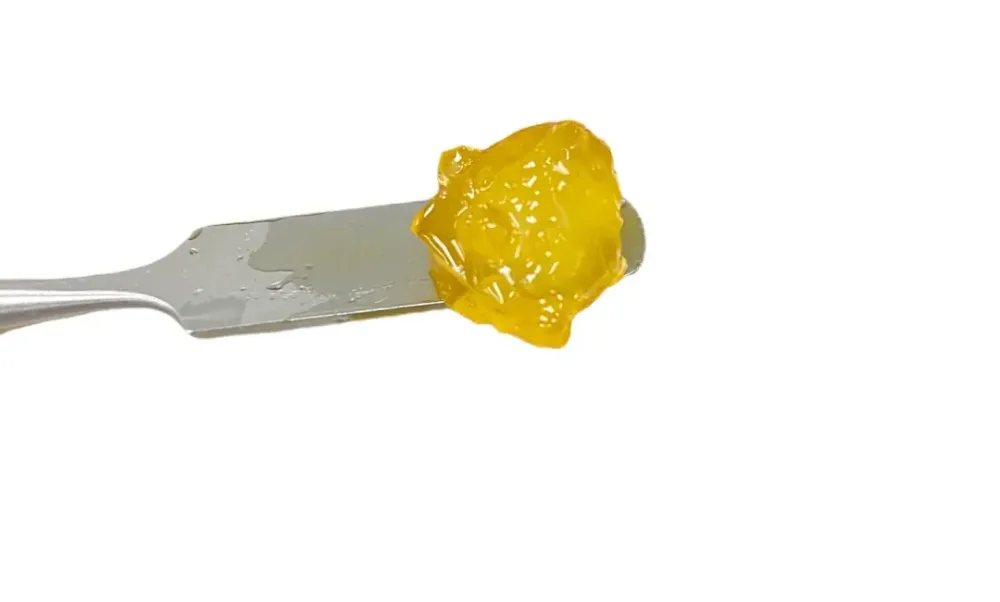 A golden Bedford Grow cannabis diamond on an extraction tool